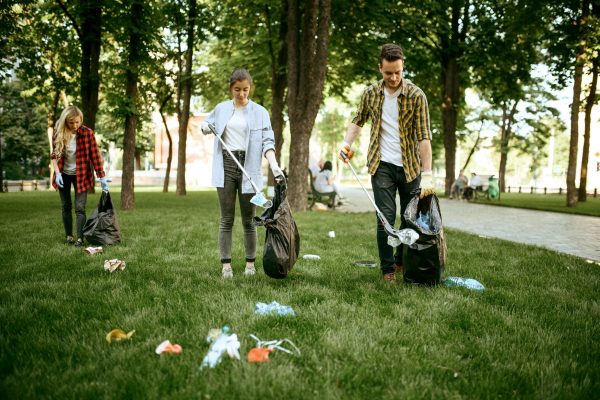 ENVATO young-people-collects-trash-in-park-volunteering-FB7MKD8 (1)