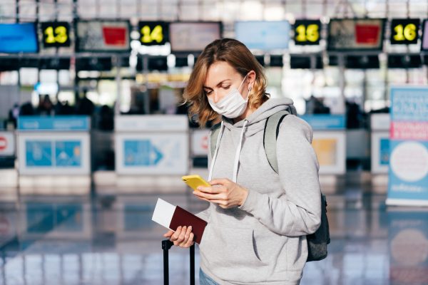 Girl With Medical Mask Standing In The Airport.