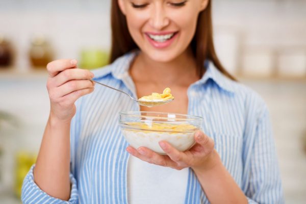 healthy-breakfast-girl-eating-cereals-with-yogurt-G49EF6X