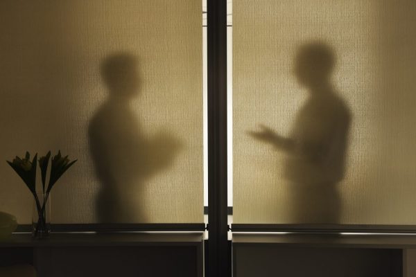 abstract-shadows-of-two-businessman-in-a-meeting-b-TNHS53T
