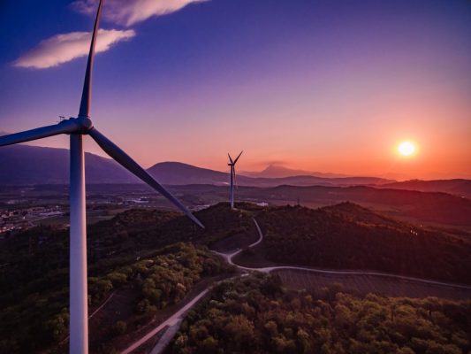 wind-turbines-windmill-energy-farm-at-sunset-in-it-2021-08-31-13-47-40-utc