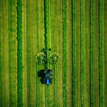 aerial-view-of-tractor-mowing-green-field-in-finla-2022-02-08-22-39-29-utc