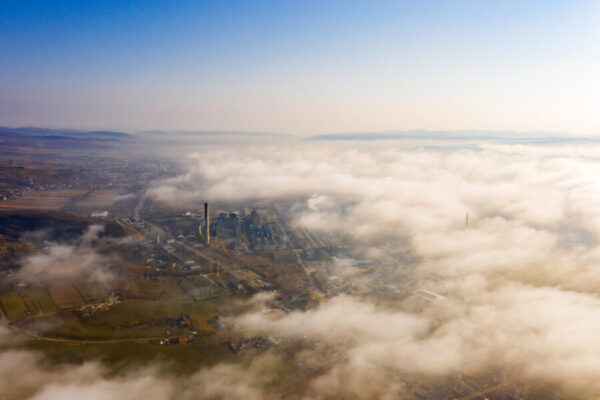 Aerial view of industrial zone covered with autumn fog in Dej, R