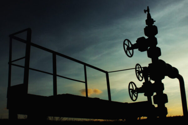unusual silhouette of gas rig drill, on the background of blue a