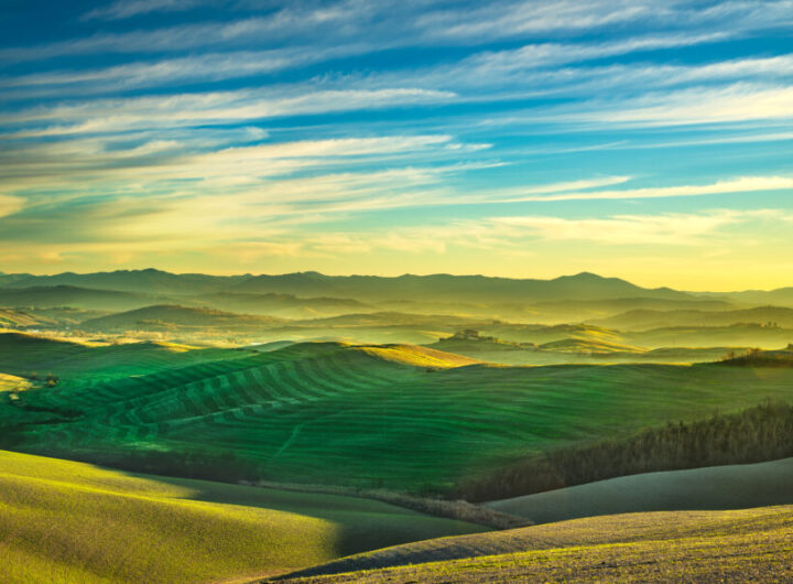 Volterra winter panorama, rolling hills and green fields on suns