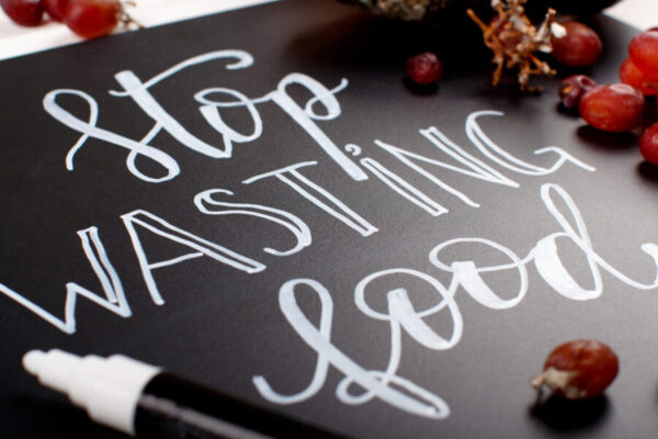 Chalkboard with Stop wasting food lettering